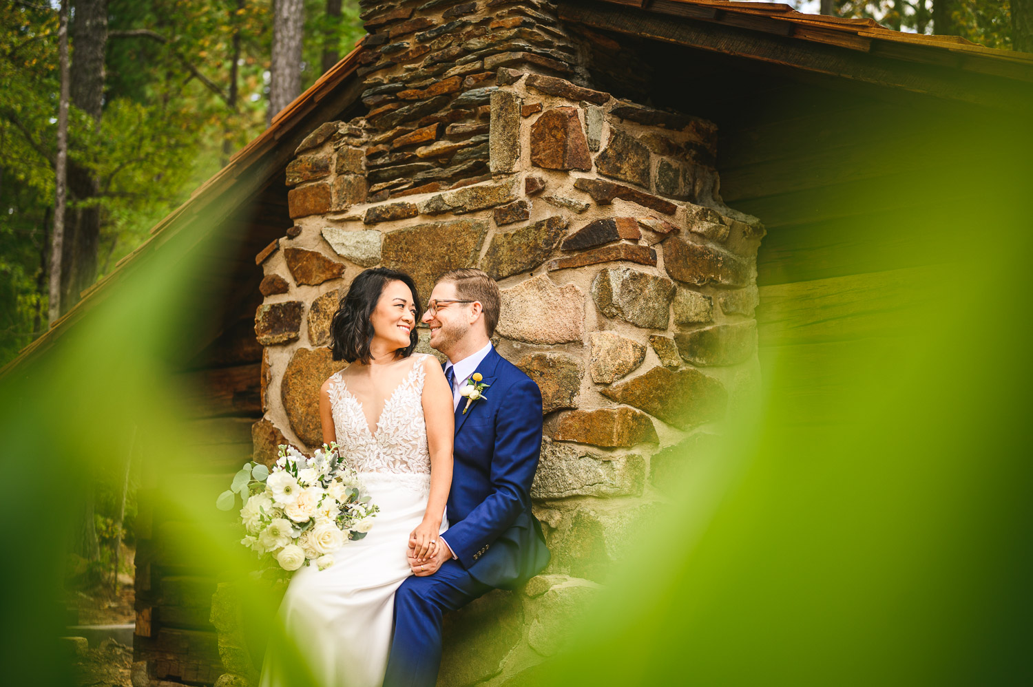 Picture of bride and groom in front of a stone chimney at YOUnion Grove Farm