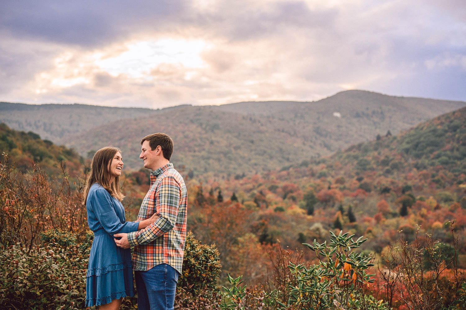 Engaged couple pose with Graveyard Fields in background