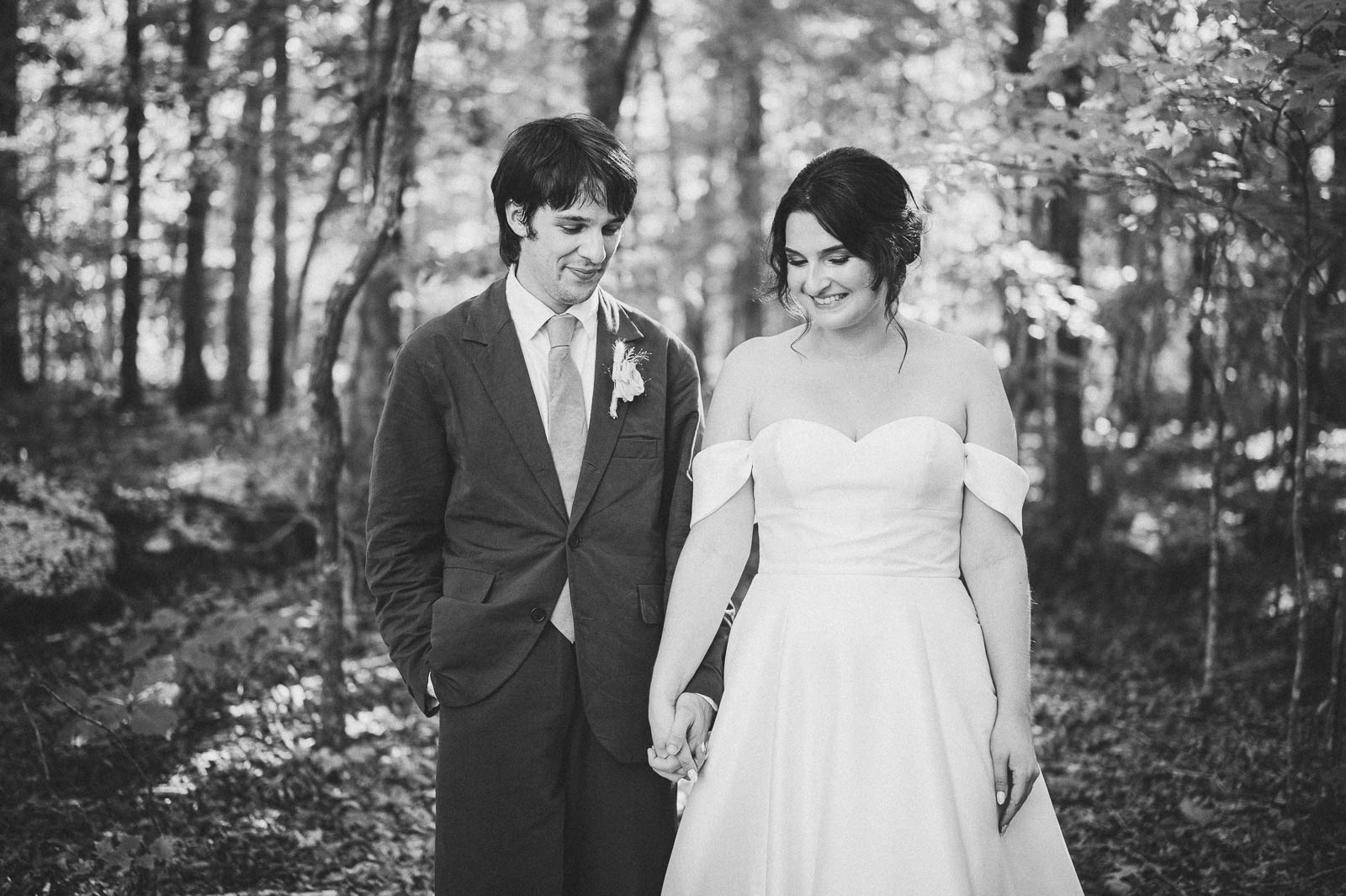An elegant photo of a bride and groom in Black and White in the woods